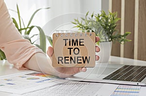 Laptop, female and notepad with text TIME TO RENEW in the white background