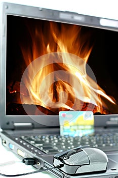 Laptop with flames on background