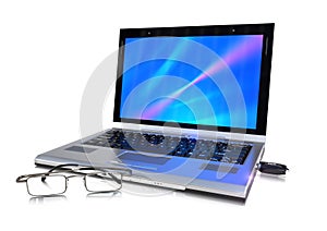 Laptop, flash drive and glasses