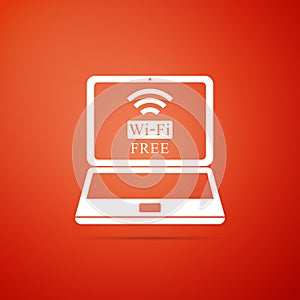 Laptop and free wi-fi wireless connection icon isolated on orange background. Wireless technology, wi-fi connection