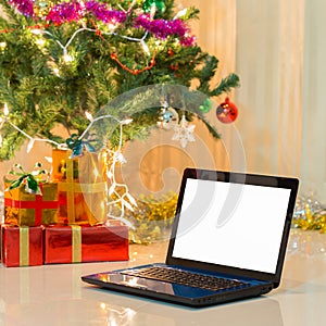 Laptop with gift box and christmas lights