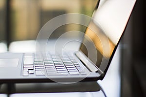 Laptop on a glass table at sunset