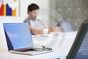 Laptop And Glasses On Desk In Design Studio