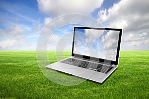 Laptop on green grass