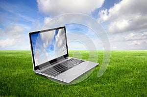 Laptop on green grass