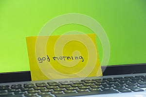 Laptop with green screen cup with coffee table and the inscription good morning in the room