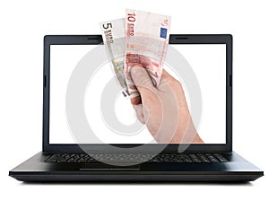 Laptop and hand giving Euro banknotes
