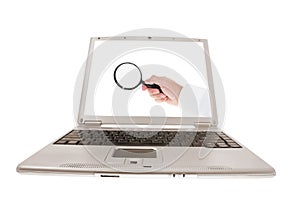 Laptop with Hand Holding Magnifying Glass