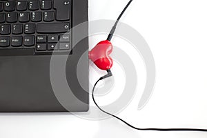 Laptop with heart shaped headphones splitter photo