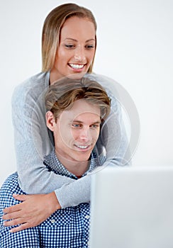 Laptop, hug and couple on internet, online website and social networking at home. Happy, dating and email with man and