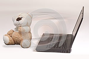 Laptop and injured toy bear