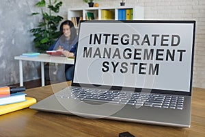 Laptop with integrated management system in office.