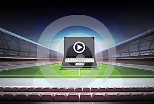 Laptop internet football watch in midfield of football stadium