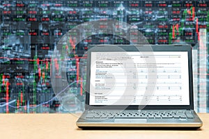 Laptop with investment screen on table with stock exchange market business trading graph. Business marketing trade concept.