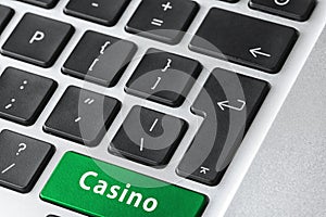 Laptop keyboard with button Casino. Online games concept