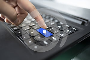 Laptop keyboard with finger pressing Heart shape key,concept happiness on the internet. closeup of male hand typing on keyboard