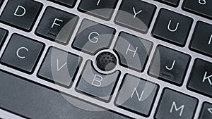 laptop keyboard with focus on pointing stick track point