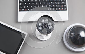 Laptop keyboard, security camera, tablet. Security