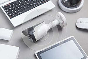 Laptop keyboard, security camera, tablet. Security