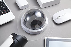 Laptop keyboard, security camera, tablet. Security