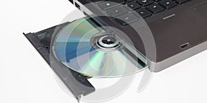 laptop is loaded with a DVD drive open CD rom tray on a white