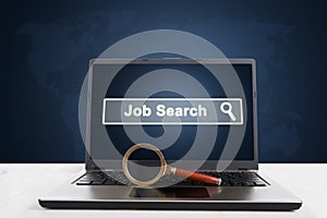 Laptop with magnifier and job search text