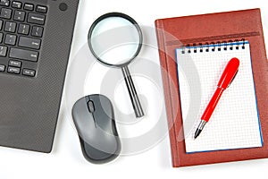 Laptop, magnifying glass, computer mouse, smartphone, pen, notepad on a white background. Items for business and buying goods