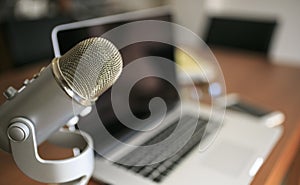 Laptop and mic a a wooden table