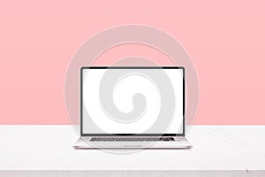 Laptop mockup on white desk with pastel pink background