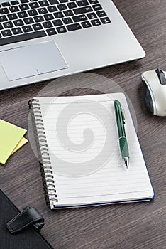 Laptop, notebook and pen with Adhesive Note