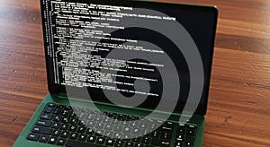 Close up of a laptop screen displaying lines of white code on a dark display