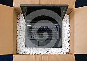 Laptop in opening package box