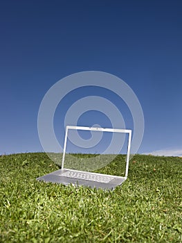 Laptop outdoors on a green field