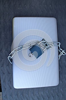 Laptop with padlock and chain
