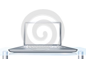 Laptop PC on glass table isolated
