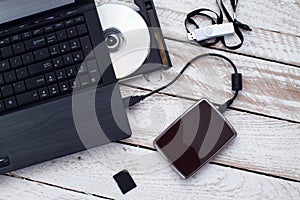 Laptop with pendrive, sd card, CD and portable hard drive. photo