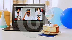 laptop with people having virtual birthday party