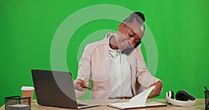 Laptop, phone call and black woman writing on green screen in studio isolated on a background. Cellphone, typing on