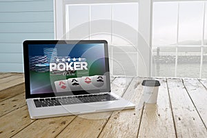 laptop with poker online website on screen with port background