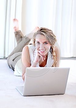 Laptop, portrait and smile of woman in house on floor, typing email and remote work. Computer, happy and face of person