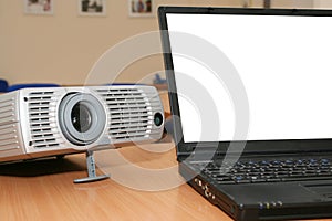 Laptop with the projector on office table