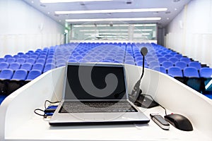 Laptop on the rostrum in conference hall. photo