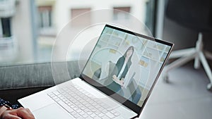 Laptop screen with experienced therapist talking with patient during psychotherapy online session