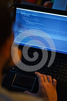 Laptop screen with lines of code. Programmer writes an application in the programming language.
