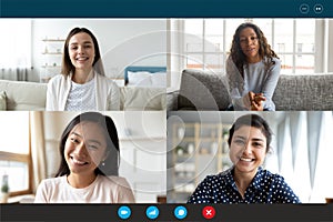 Laptop screen webcam view multiethnic women involved in group videocall photo