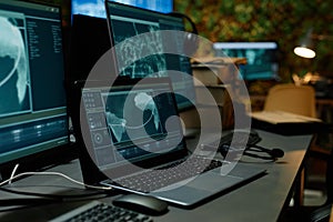 Laptop with secret data on screen standing on workplace of officer