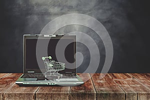 laptop with shopping cart on wood table ,shopping on line