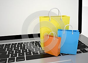 Laptop and shopping pags