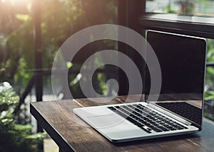 Laptop showing blank screen in coffee shop restaurant, Comfortable working place, Close-up of comfortable working place in office