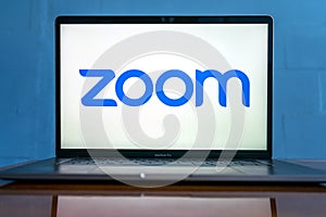 Laptop showing Zoom Cloud Meetings app logo.